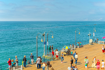 Famous Pier in Santa Monica with tourists, a suburb of Los Angeles.