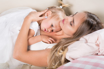 mother and daughter sitting on the couch