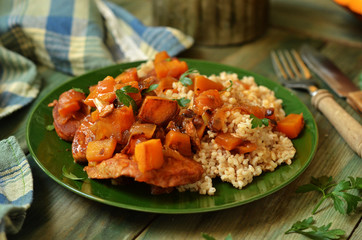 Tenderloin with pumpkin on a wooden background