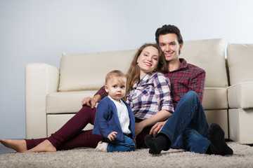 Family with a baby in a room with a sofa