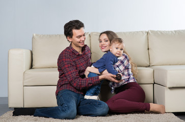 Family with a baby in a room with a sofa