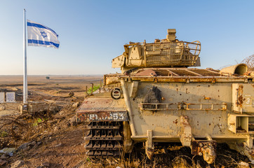 Israeli flag flying beside a decommissioned Israeli Centurion tank used during the Yom Kippur War at Tel Saki on the Golan Heights in Israel 