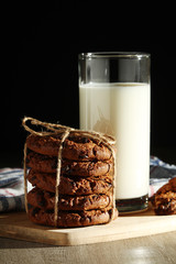 A glass with milk and chocolate cookies