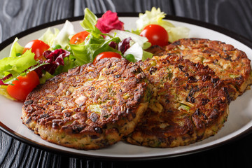 Vegetarian menu: mushroom vegetable patty with fresh salad on a plate close-up. horizontal