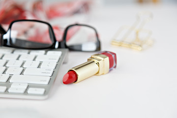 white keyboard with black glasses in white desk