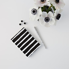 black and white notebook and flowers