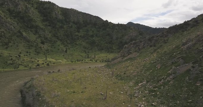 Scenic green rocky cliff mountain next to Madison river valley Beartrap Canyon at Bozeman Montana
(drone shot)