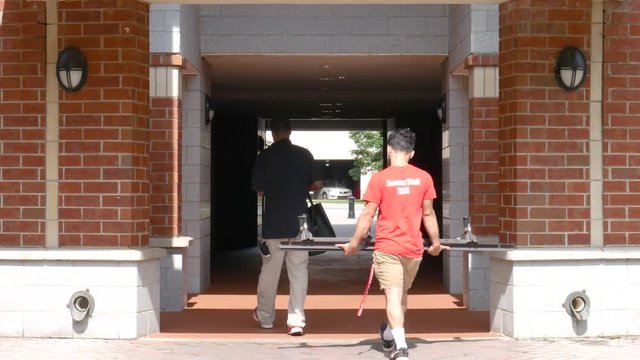 Athens, GA - July 5, 2018: Students carry furniture into their newly renovated dorm on move-in day during the summer at The University of Georgia in Athens, Georgia.