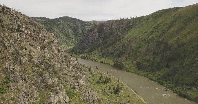 Beartrap Canyon trail green rocky mountains next to Madison river valley in Bozeman Montana countryside
(drone shot)
