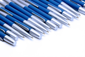 Silver-blue metal pens isolated on white background.