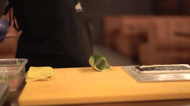 Process of peeling cucumber.  Preparing vegetables for sushi roll.