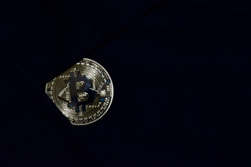 Bitcoin gold on black fabric background. for savings bitcoin to secure. Business concept