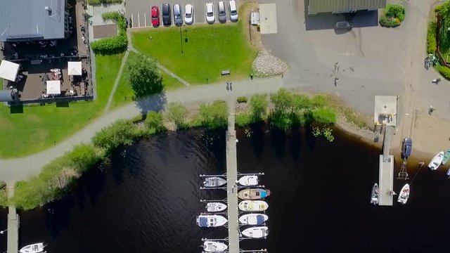 A quiet harbor next to a club and a parking lot.