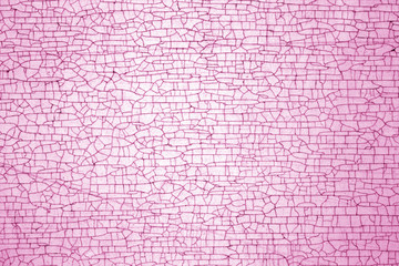 Cracks on metal colored texture in pink tone.
