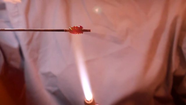 Heating a Twisted Molten Glass Bead over a Gas Torch