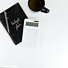 calculator and notebook on white background