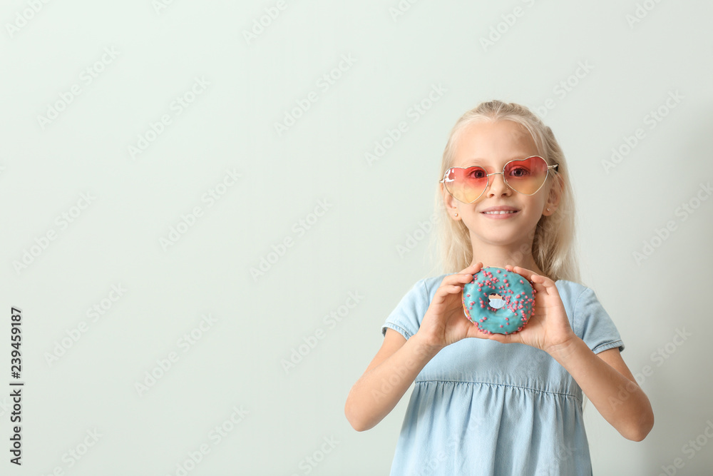 Sticker cute little girl with donut on light background