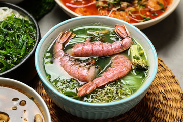 Assortment of tasty Chinese soups on table
