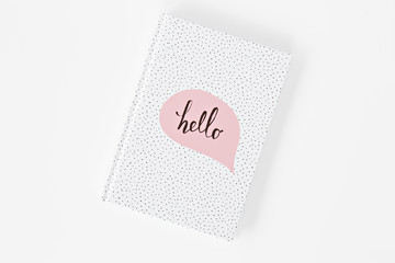 white notebook with pink sticker