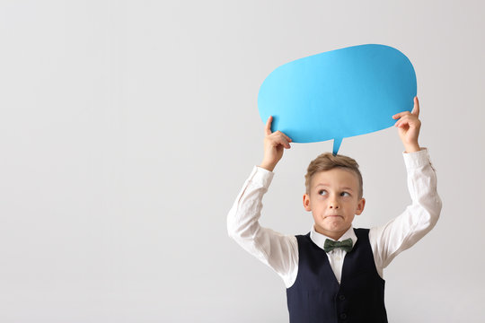 Little boy with blank speech bubble on white background