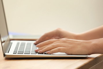 Woman using laptop in office, closeup