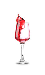 Glass with red splashing wine on white background