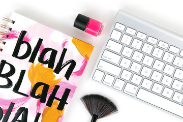 notebook with keyboard and makeup brush