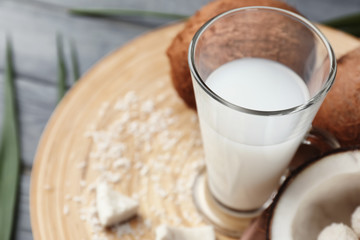 Glass of tasty coconut water on table, closeup