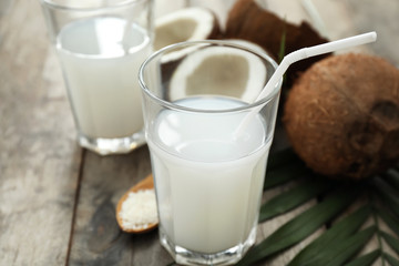 Glasses of tasty coconut water on table