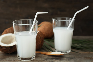 Glasses of tasty coconut water on table