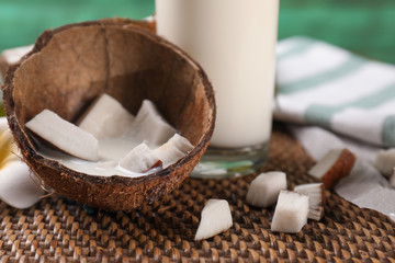 Coconut shell with milk on table