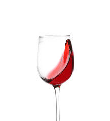 Glass with red splashing wine on white background