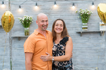 Naklejka premium Funny mature couple standing on grey background. Middle-aged couple standing on grey background. Couple standing on grey background