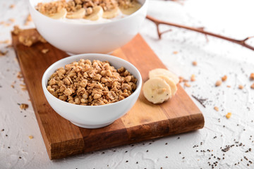 Bowl with tasty granola on white table