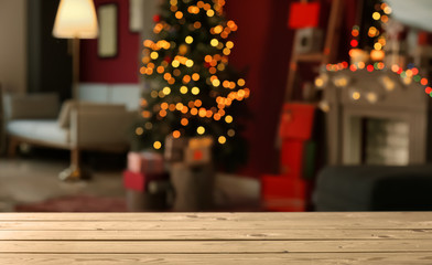 Wooden table against blurred interior of room