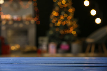 Blue wooden table against blurred interior of room
