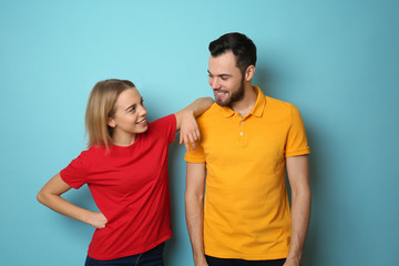 Fototapeta premium Stylish young couple on color background