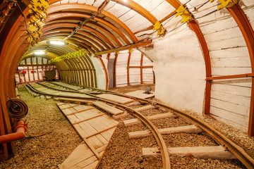 Mine tunnel with rails and tub. Mine tunnel ceiling.