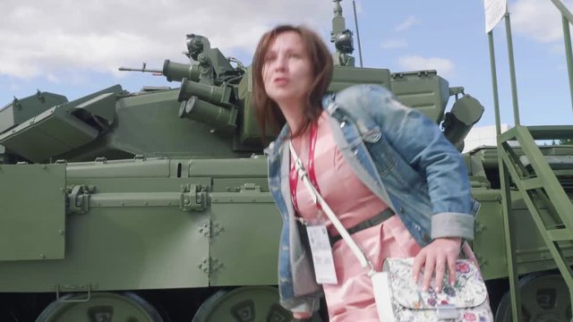Woman is going down from main battle tank