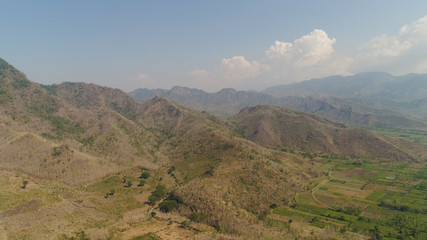 Fototapeta na wymiar aerial view mountain hilly landscape in asia. mountain range with high cliffs mountain slopes covered with vegetation