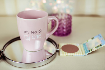 Cup of coffee on a mirror with blurred background