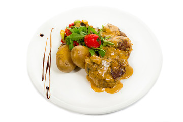 Pork Medallions with Potato and Mushrooms isolated on white.