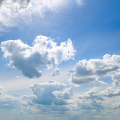 Light cirrus and cumulus clouds against the blue sky.