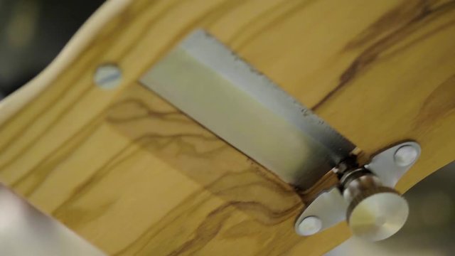 Close up on a waiter slicing fresh white truffle onto a fine dining dish in an expensive Italian restaurant.