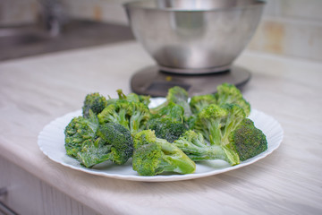 Broccoli on new electronic kitchen scales. Healthy eating concept. Vegan food