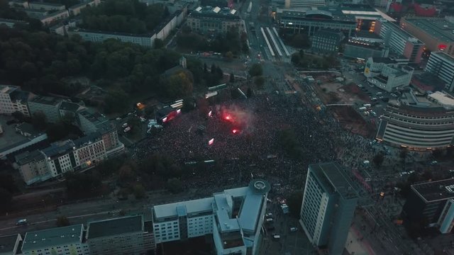 Aerial drone panning above Cheminitz, Germany city as thousands people attend an open air rock concert to stand together against racism with one large stage and people sprawled throughout the streets