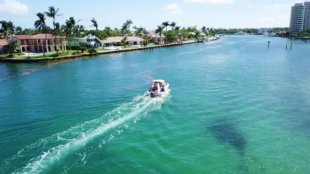Awesome footage following a boat on an aqua marine blue-green Intracoastal waters.