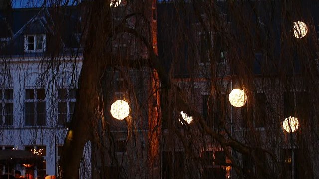 Brugge, Belgium at Christmas time : decorated tree reflecting on water canal