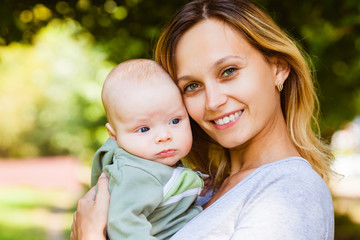 Close up portrait of a smiling mother and baby