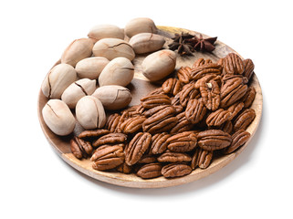Plate with pecan nuts on white background